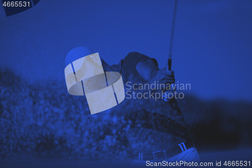 Image of golfer hitting a sand bunker shot