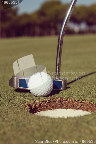 Image of hitting golf ball to hole