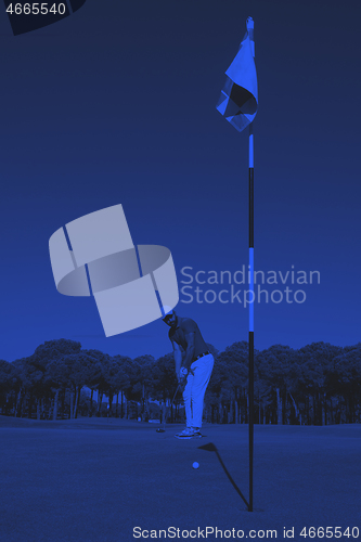 Image of golf player hitting shot at sunny day