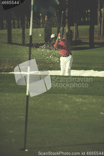 Image of golfer hitting a sand bunker shot