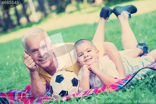 Image of grandfather and child have fun  in park