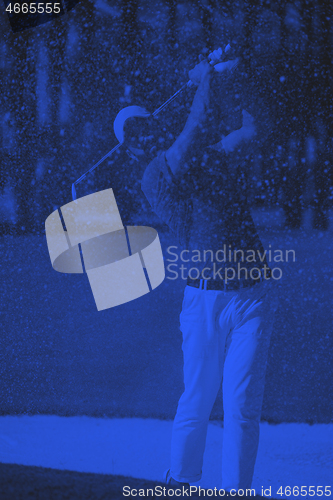 Image of golfer hitting a sand bunker shot