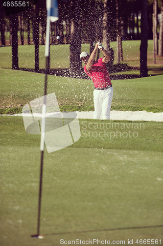 Image of golfer hitting a sand bunker shot