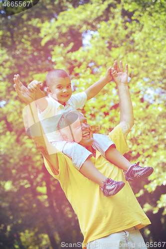 Image of happy grandfather and child in park