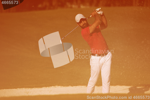 Image of golfer hitting a sand bunker shot