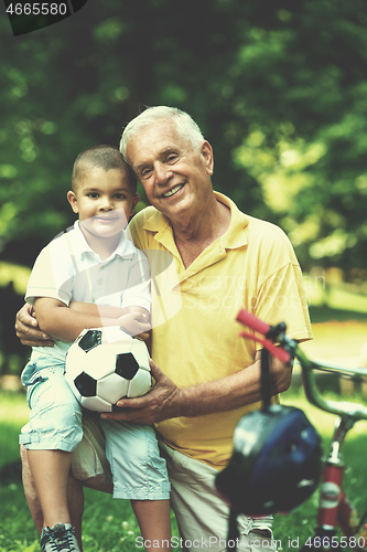 Image of grandfather and child have fun  in park