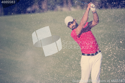 Image of golfer hitting a sand bunker shot