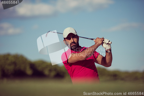 Image of golfer hitting a sand bunker shot