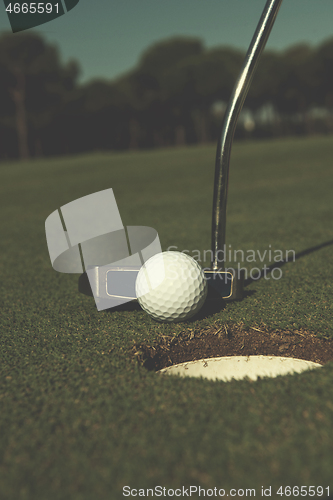 Image of hitting golf ball to hole