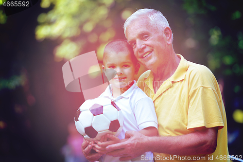 Image of happy grandfather and child in park