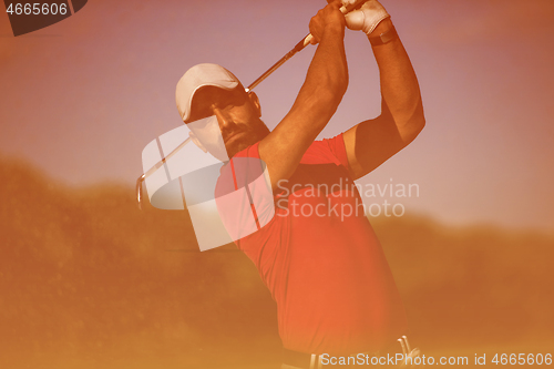 Image of golfer hitting a sand bunker shot