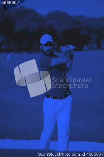 Image of golfer hitting a sand bunker shot