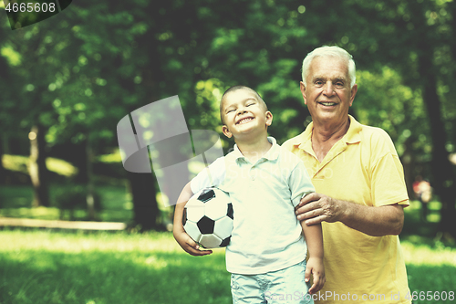 Image of grandfather and child have fun  in park