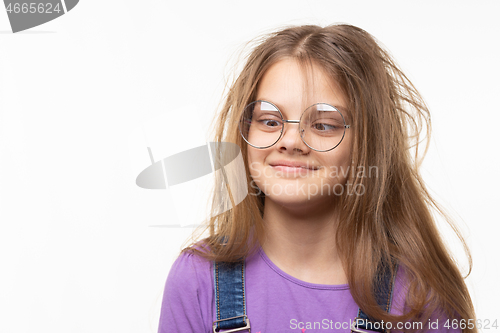 Image of Girl with glasses trying to look at her nose.