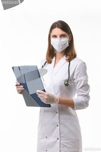 Image of Portrait of a doctor girl in a medical mask and gloves