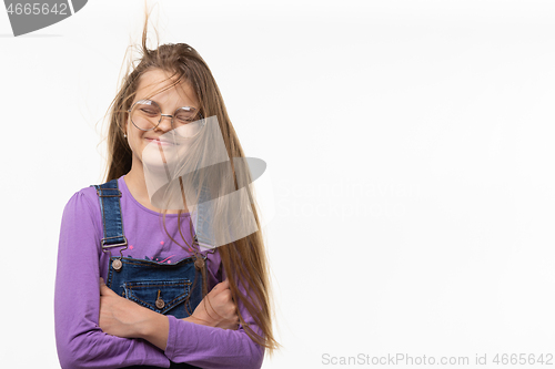 Image of A girl of eleven from the wind tangled in long hair