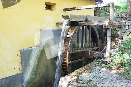 Image of Old wooden wheel from a mill on the river