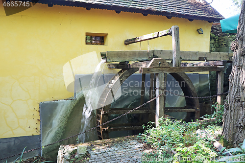 Image of Old wooden wheel from a mill on the river