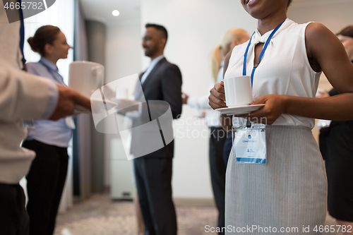 Image of business people with conference badges and coffee