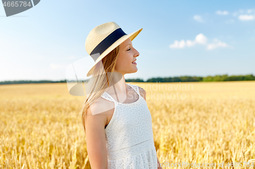 Image of portrait of girl in straw hat on field in summer