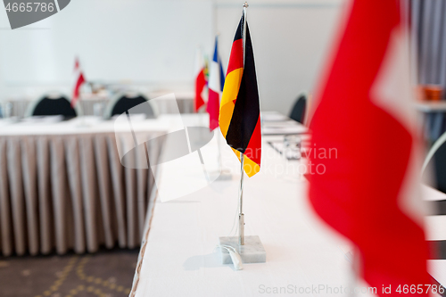 Image of flags at international conference boardroom