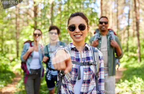 Image of friends with backpacks on hike in forest