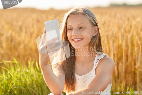 Image of happy young girl taking selfie by smartphone