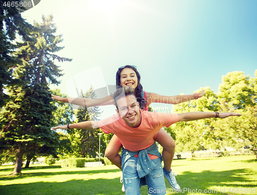 Image of happy teenage couple having fun at summer park