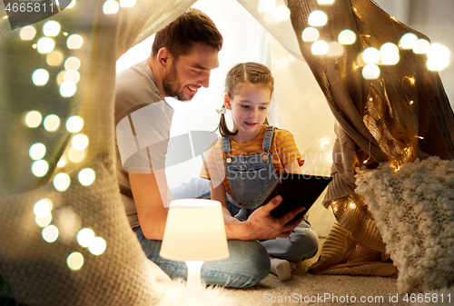 Image of family with tablet pc in kids tent at home