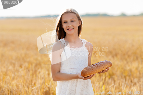 Image of girl with loaf of white bread on cereal field