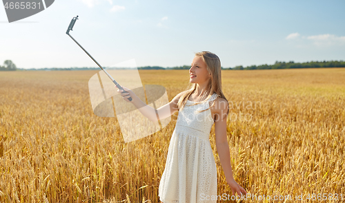 Image of happy young girl taking selfie by smartphone