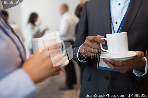 Image of business people with conference badges and coffee