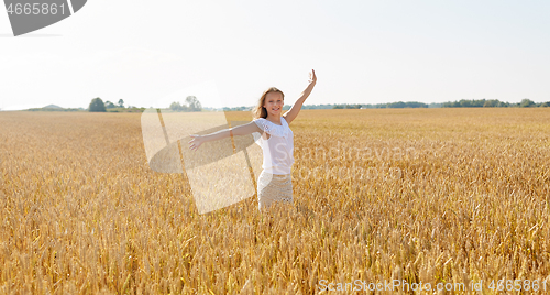 Image of happy smiling young girl on cereal field in summer