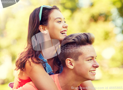 Image of happy teenage couple having fun at summer park