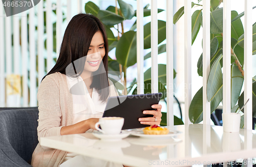 Image of asian woman with tablet pc at cafe or coffee shop