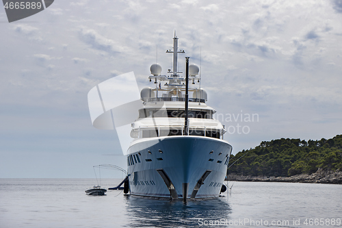 Image of Blue luxury motor yacht, anchored in the calm sea