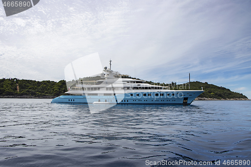 Image of Blue luxury motor yacht, anchored in the calm sea