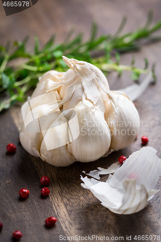 Image of Garlic with red pepper and herbs on wooden background