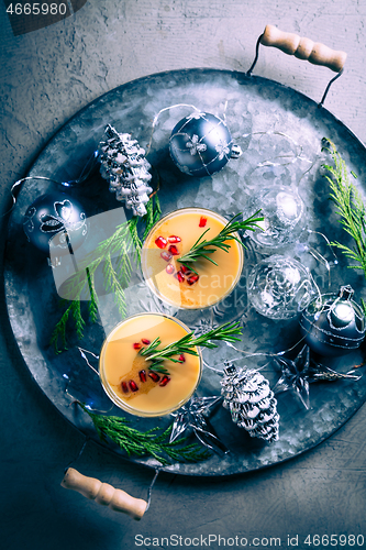 Image of Traditional egg liqueur or eggnog with cinnamon, pomegranate and rosemary for Christmas