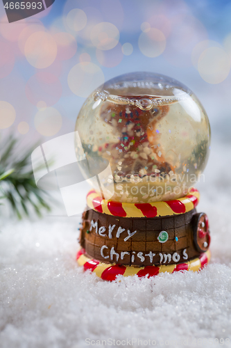 Image of Snowball on snow with blurry background. Symbol of winter and Christmas.