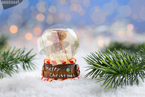 Image of Snowball on snow with blurry background. Symbol of winter and Christmas.