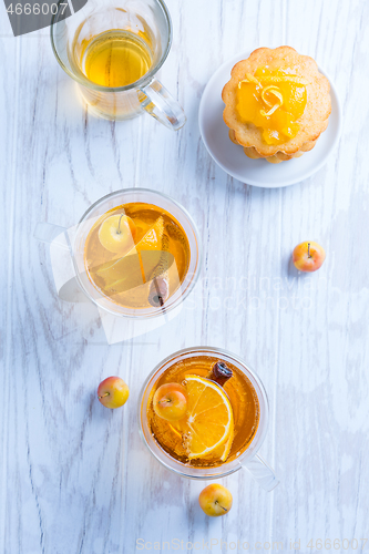 Image of Apple cider cocktail with cinnamon and small lemon curd tarts