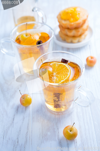 Image of Apple cider cocktail with cinnamon and small lemon curd tarts