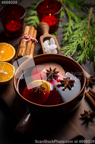 Image of Spicy mulled wine with orange, apple, cinnamon and anise in pot