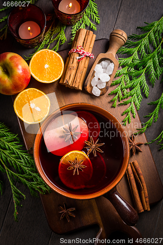 Image of Spicy mulled wine with orange, apple, cinnamon and anise in pot