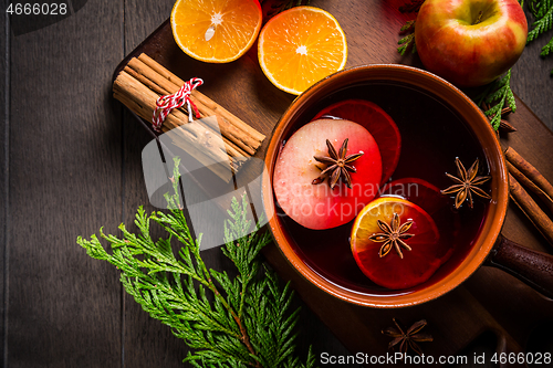 Image of Spicy mulled wine with orange, apple, cinnamon and anise in pot