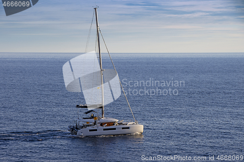 Image of Small Sailing boat yacht in the open blue Sea