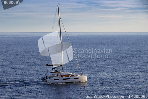 Image of Small Sailing boat yacht in the open blue Sea