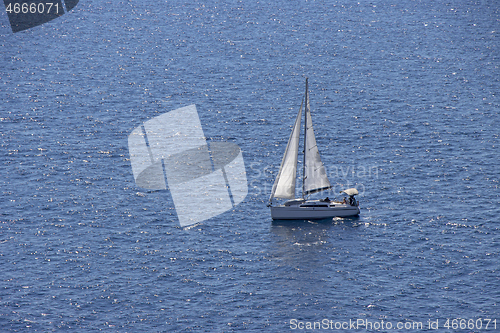 Image of Small Sailing boat yacht in the open blue Sea