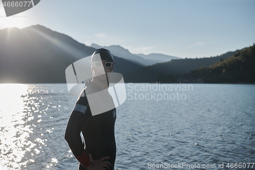 Image of triathlon athlete starting swimming training on lake